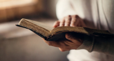 Christian assisted-living facility resident reading Bible